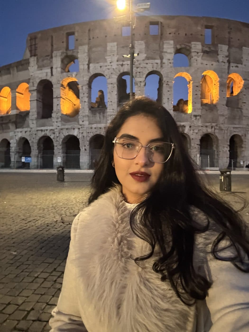 Bianca in front of the Colosseum at night