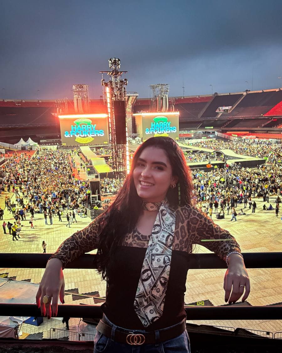 Bianca at a Harry Styles concert, with the stadium and stage behind her