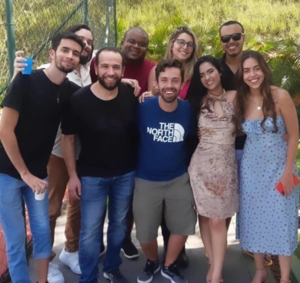 The XNV team together outdoors on a sunny day.